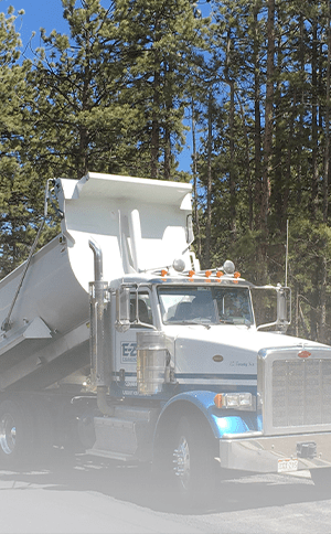 large truck helping pour asphalt